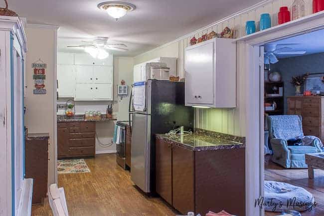 galley kitchen and living room before a major remodel