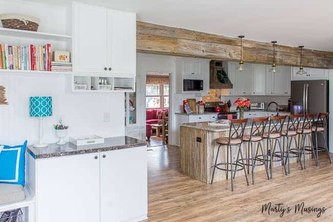 A room filled with furniture and a refrigerator in a kitchen