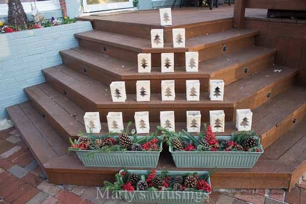 Christmas tree luminaries on your front deck or porch with shaped luminaries and planters.