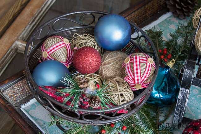 rustic ornaments in metal basket with greenery