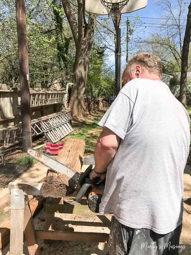 A man standing in front of a picnic table