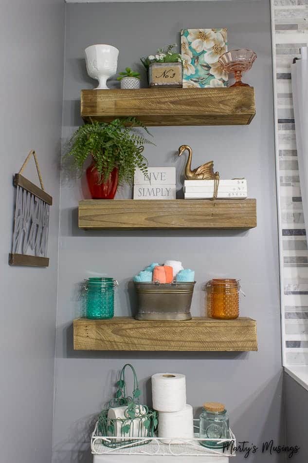 use repurposed floating shelves to make a small bathroom look larger