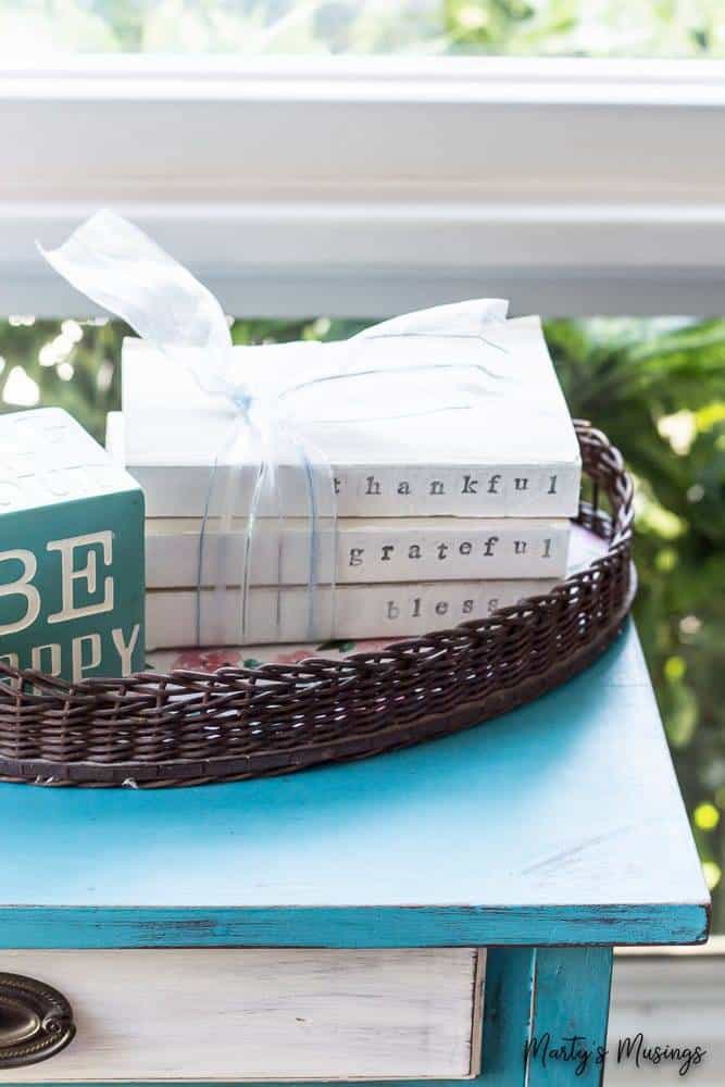 Blue table with chalk painted books on top