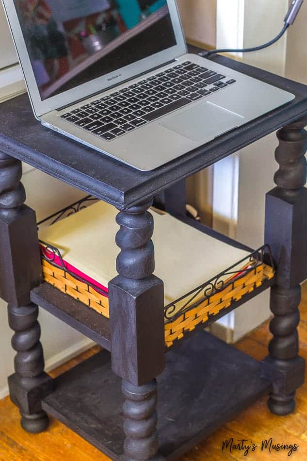 A laptop computer sitting on top of a wooden table