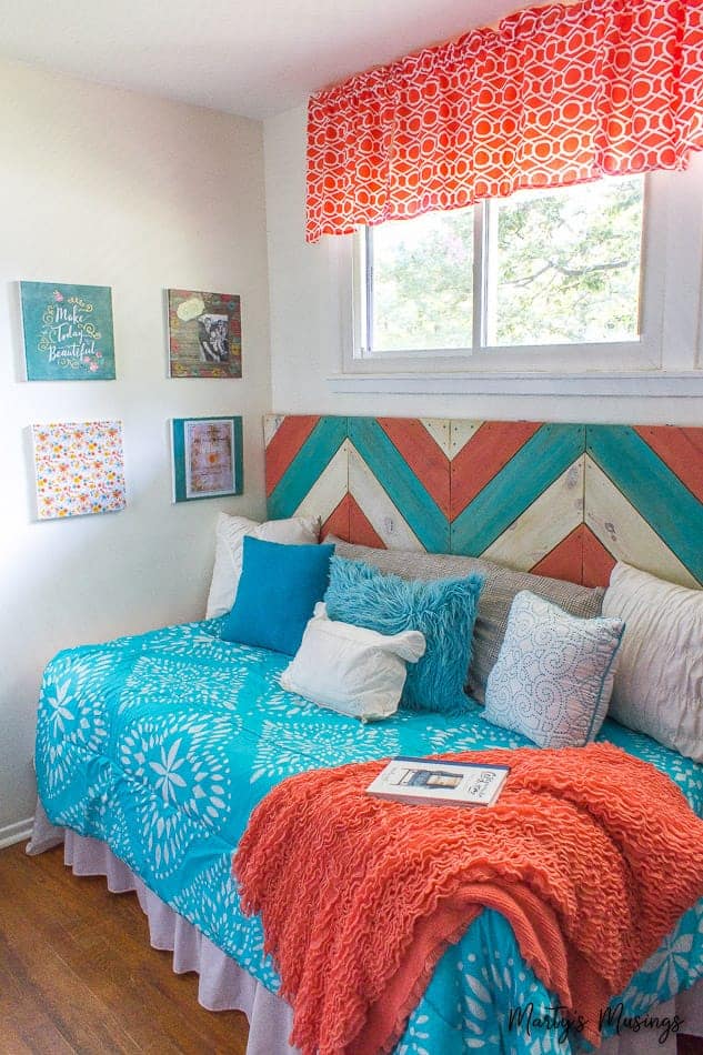 A bedroom with a colorful blanket