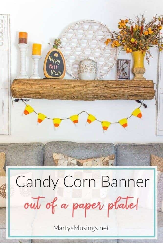 candy corn banner hung from barn wood mantel