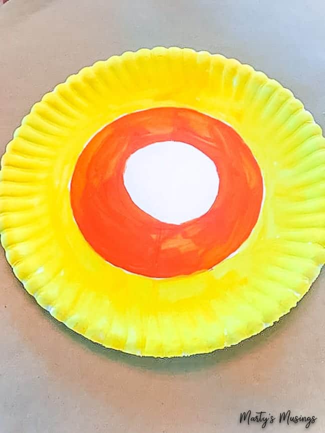paper plate painted with orange yellow circles