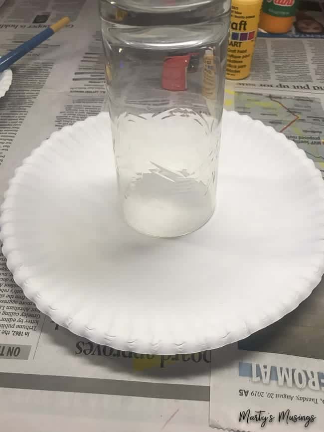 trace circle on paper plate with drinking glass