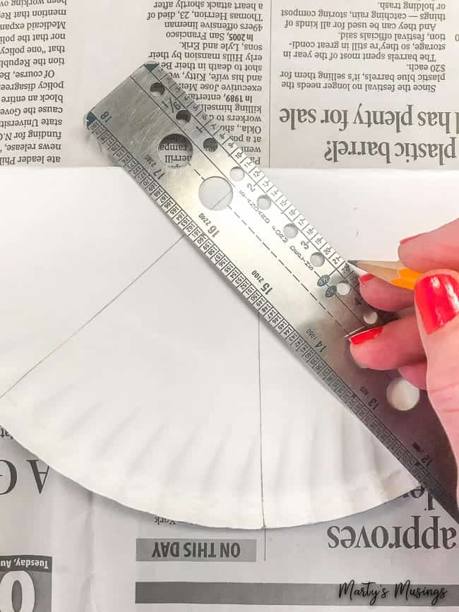 trace lines on folded paper plate with ruler and pencil