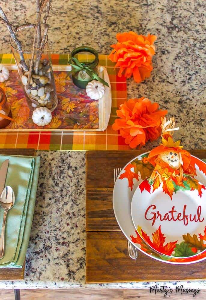 orange tissue pom poms on fall table