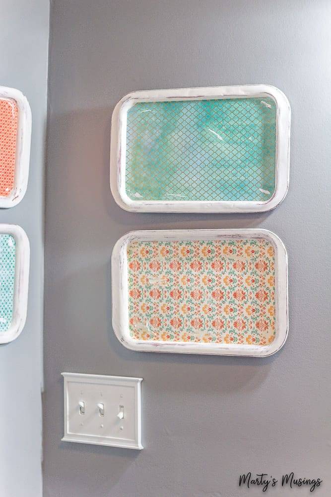 Trays hanging on wall with patterned paper inside