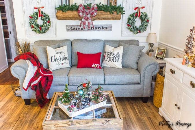 Red and green Christmas decorations in rustic living area