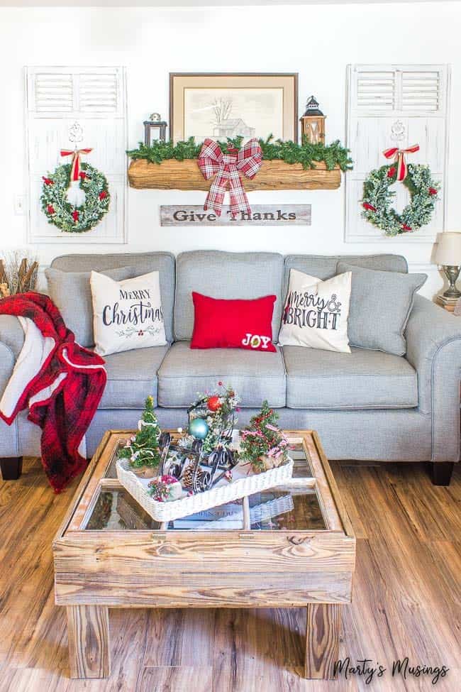 Blue sofa with wood mantel and Christmas decorations