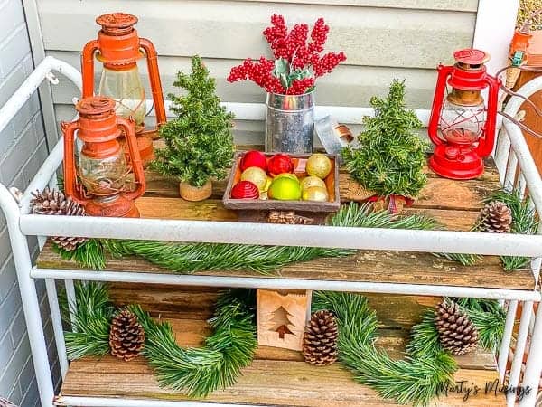 DIY garden cart decorated with greenery and lanterns