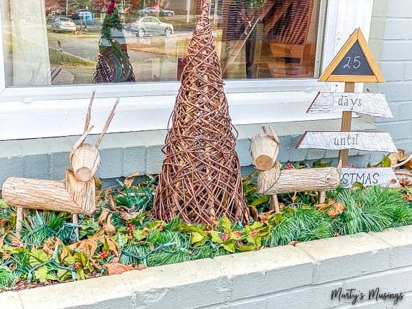 built-in planter decorated for Christmas with wooden reindeers