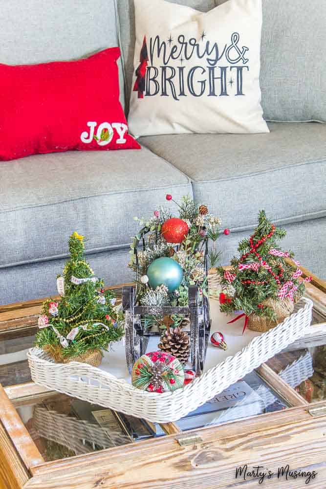 white tray with metal sleigh and Christmas pillows