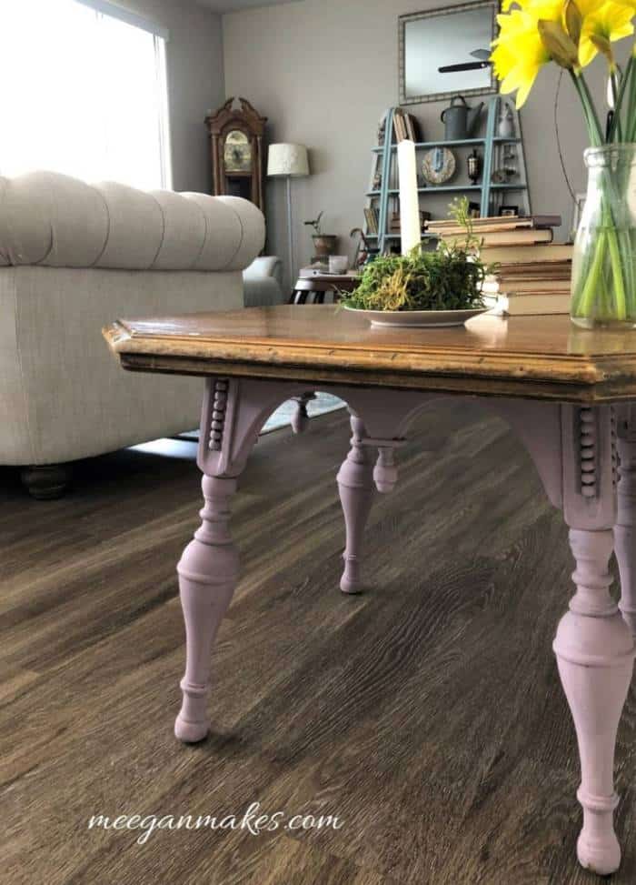 A living room filled with furniture and vase of flowers on a table