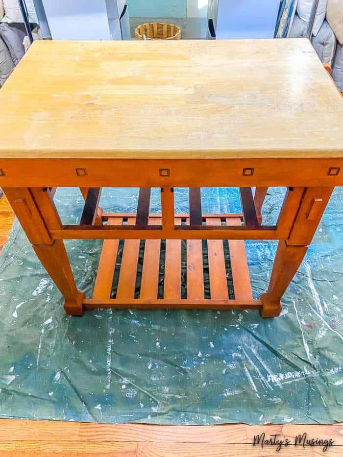 A wooden bench sitting on top of a table