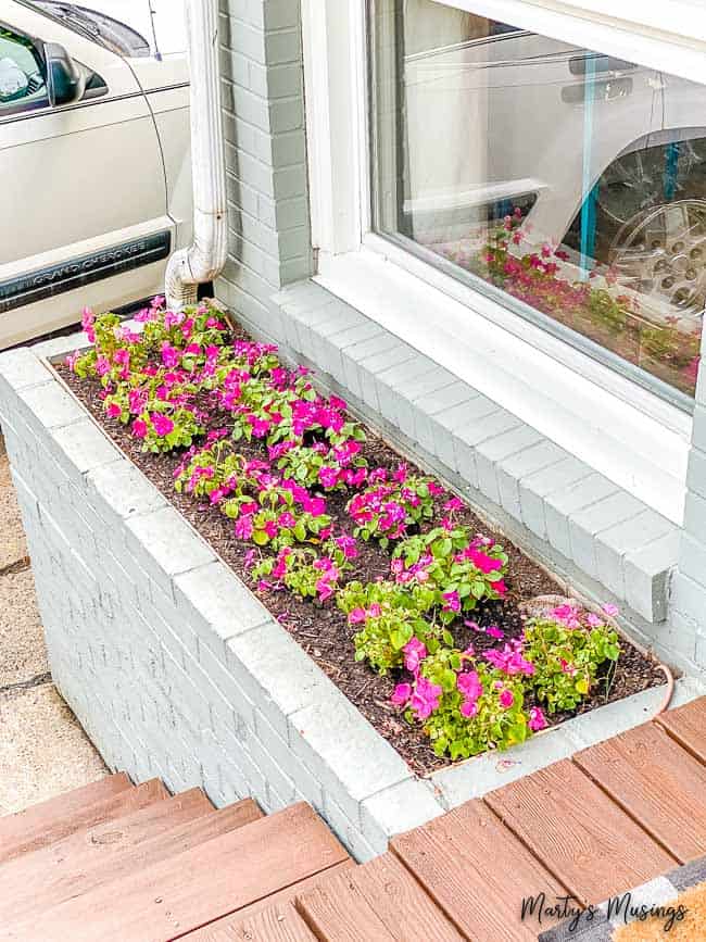 concrete built in flower bed beside front door