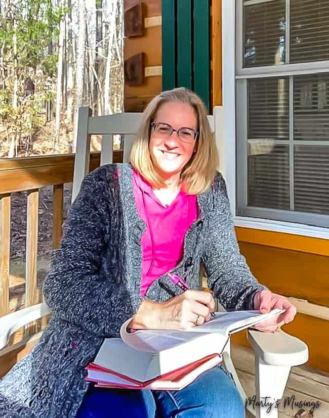 A woman sitting at a table in front of a window