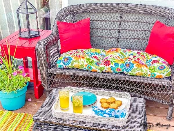 deck furniture with red table and blue flower planter