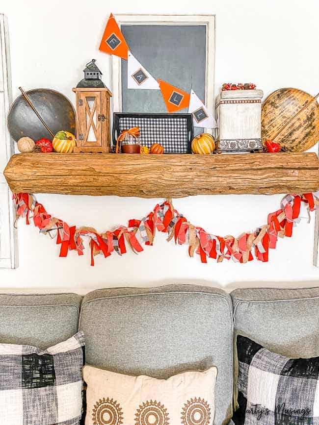 Barnwood fall mantel with a fabric banner and black and white accents