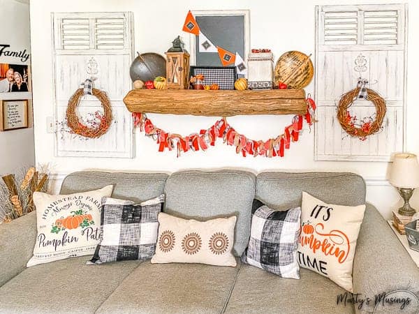 Fall mantel with rag banner hanging under barn wood mantel