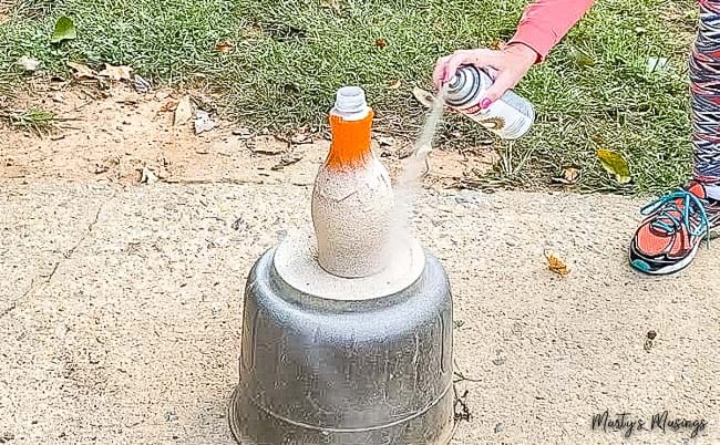 make a DIY textured vase with spray paint outdoors with plastic milk carton