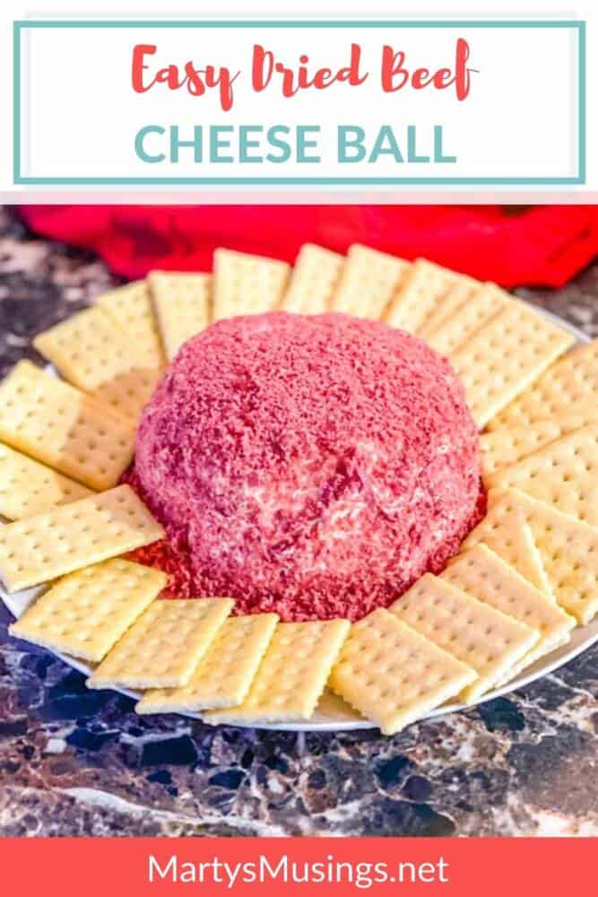 cheese ball covered in dried beef with crackers on plate