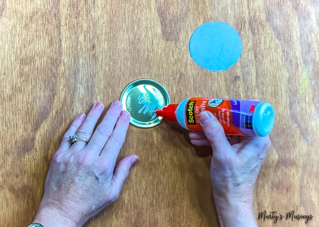 Add glue to mason jar lid