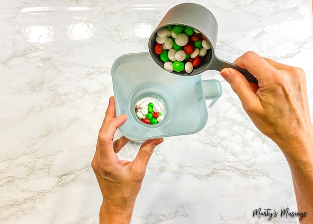 Pour M&M's into funnel