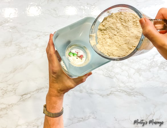 Pour flour into mason jar