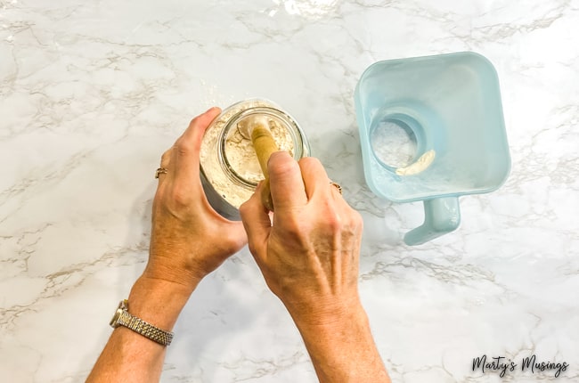 Tamp down flour in mason jar