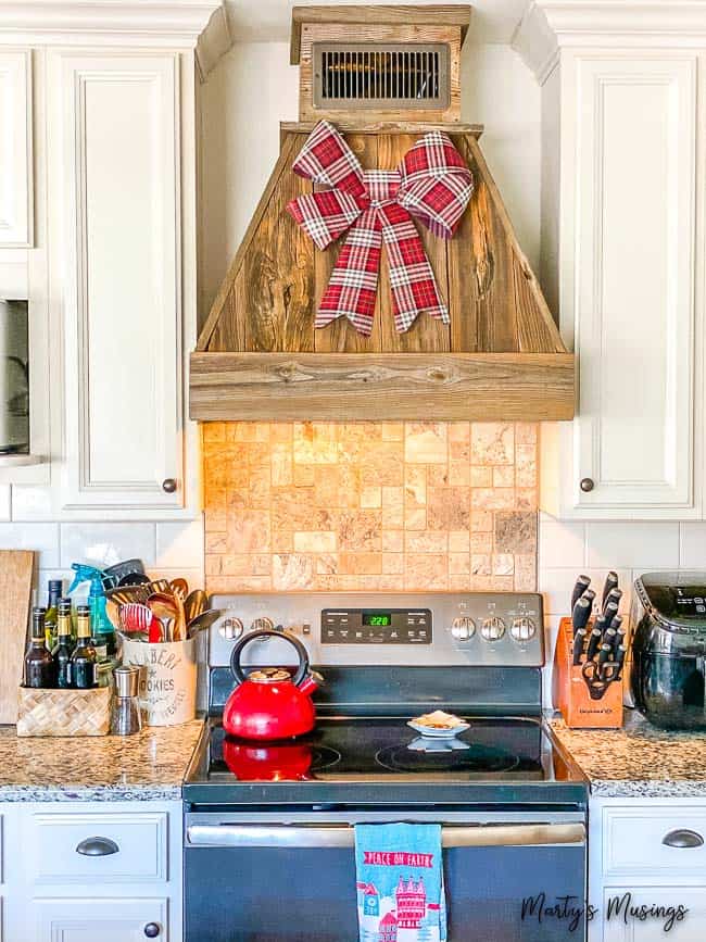 red and black buffalo check bow on rustic wood vent hood