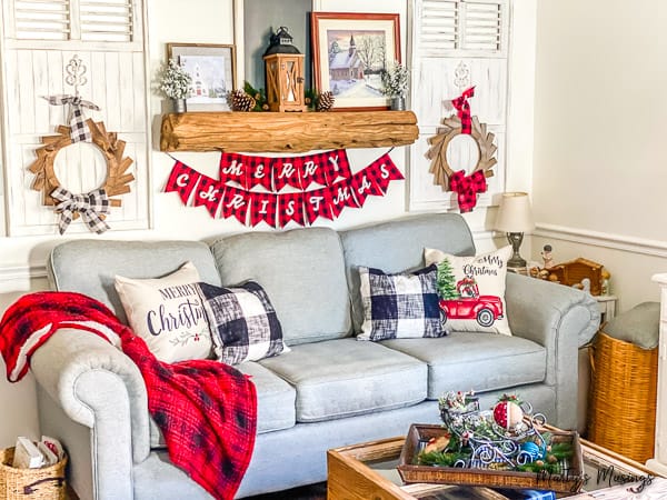 corner of Christmas room decorated with red and black buffalo plaid and rustic wood accents