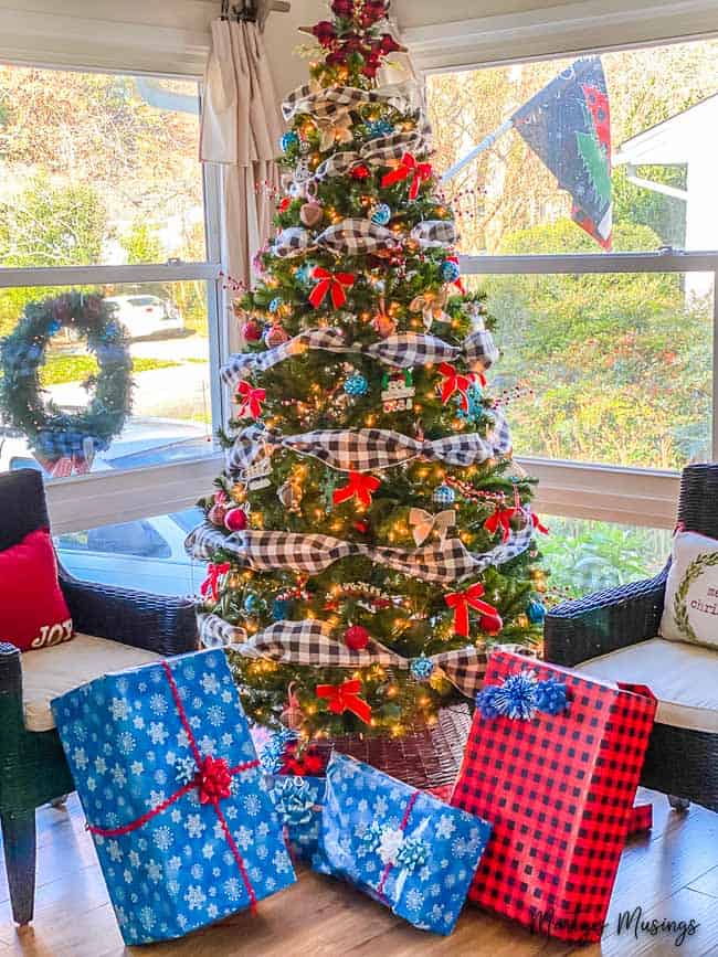 Christmas tree with blue and red buffalo plaid accents with ornaments and presents