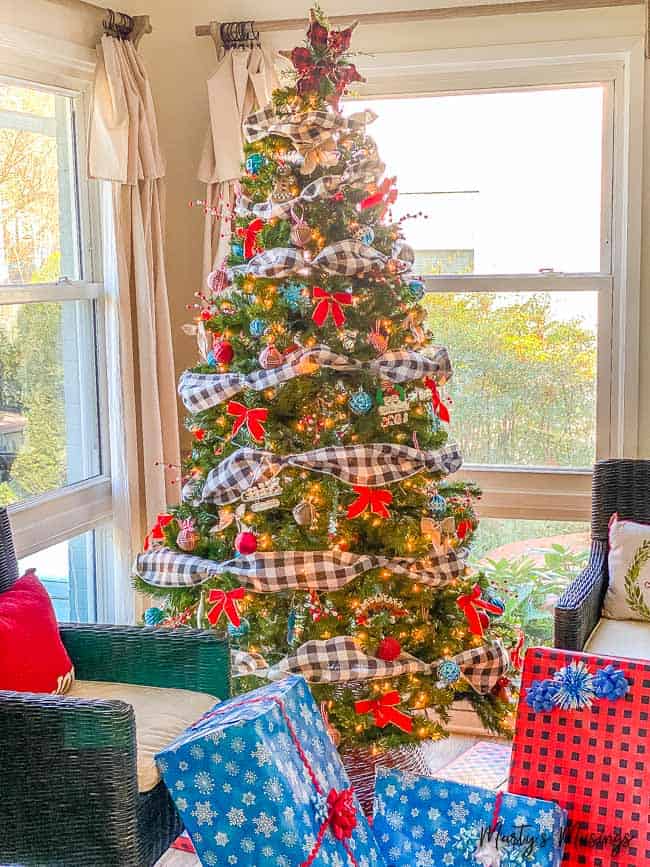 Black and white check ribbon on Christmas tree with red and blue ornaments