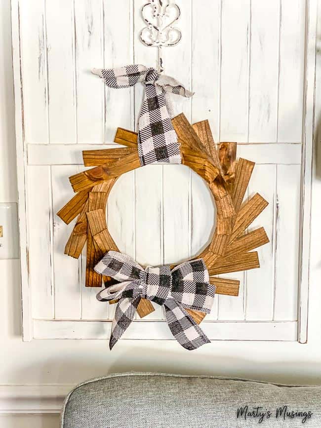 Wood shim wreath with buffalo plaid ribbon