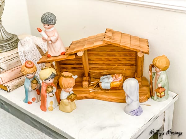 Precious Moments ceramic nativity center on a side table