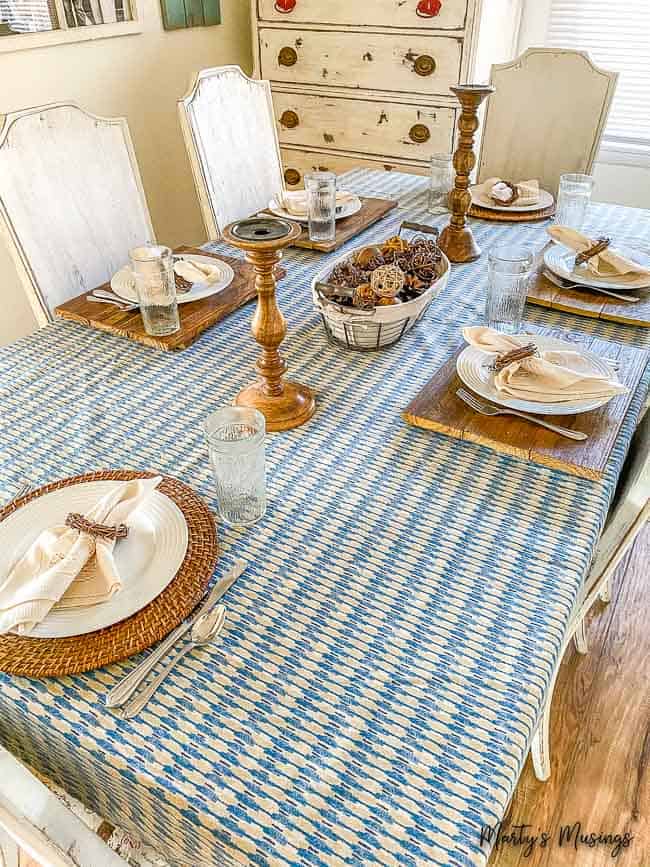 blue vintage sheet used as table cloth with wood accessories