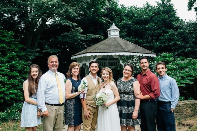 family picture outside with bride and groom