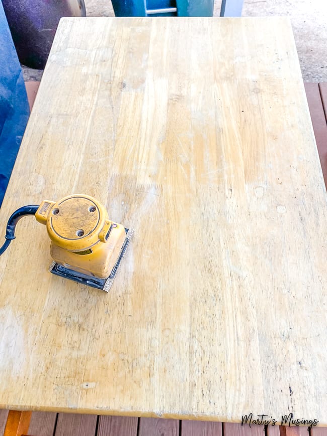 Hand sander on top of old wood surface