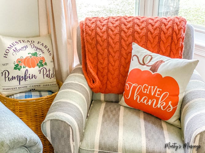 striped chair with orange cable throw and give thanks pillow