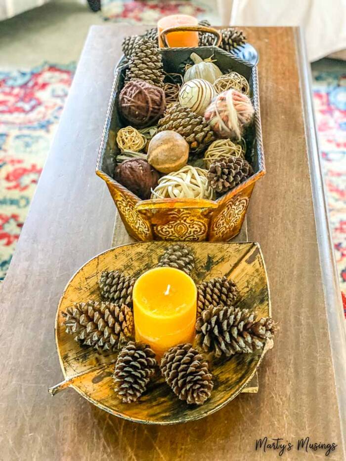 Pinecones arranged in star shape with candle in center