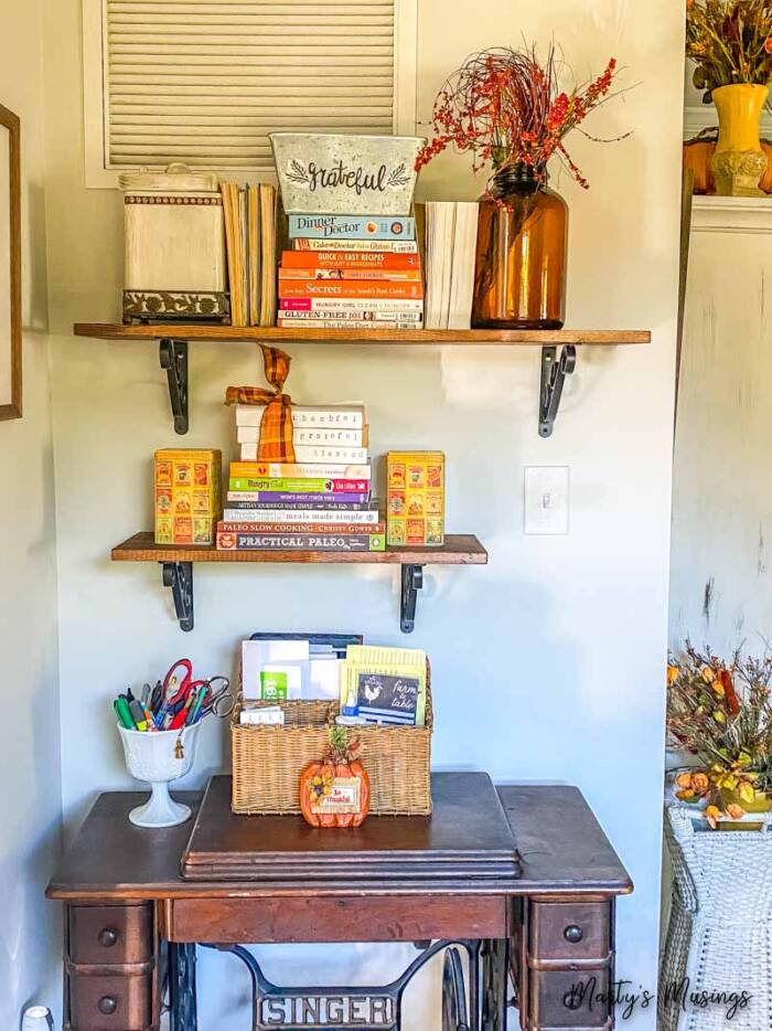 rustic shelves above vintage sewing table decorated for fall 