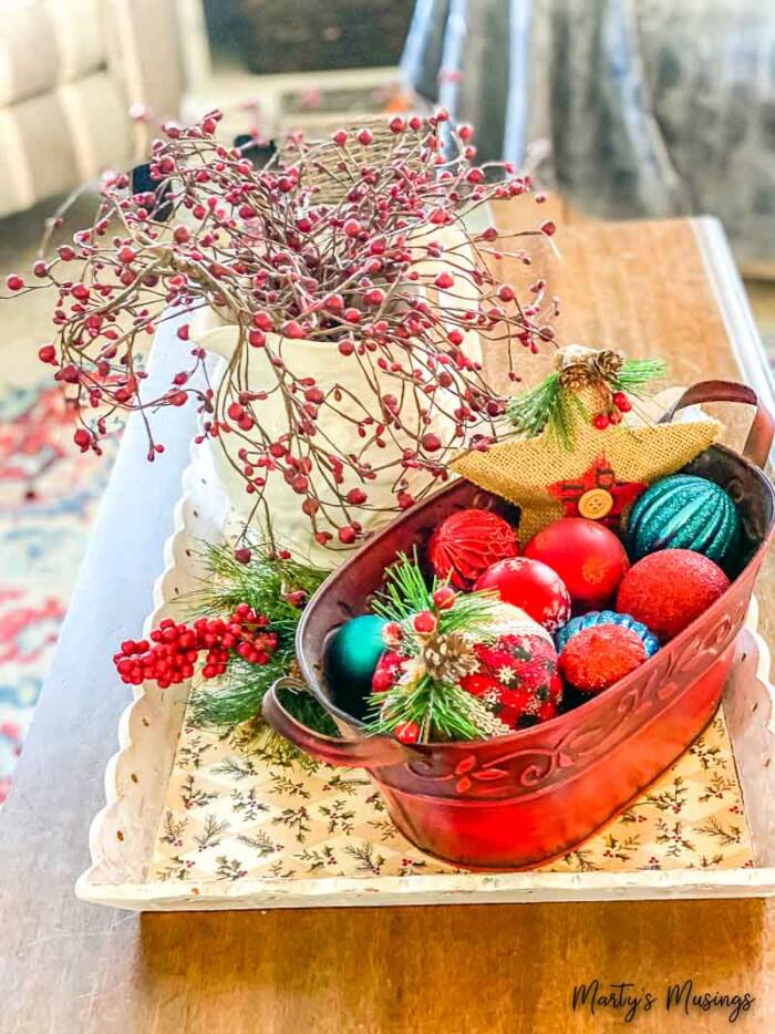 Christmas ornaments in red container on a Christmas tray