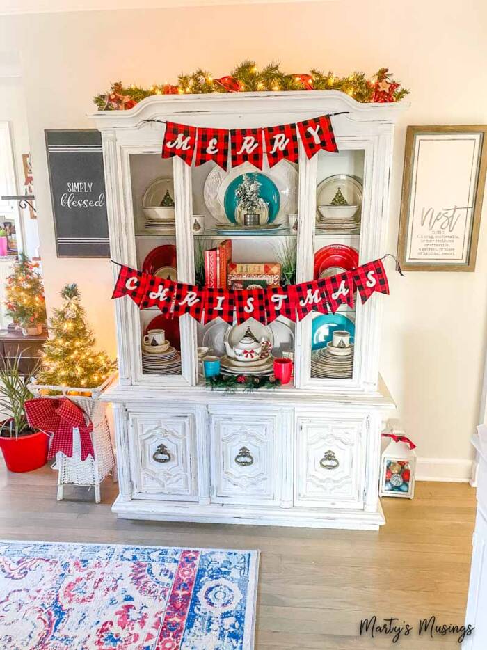 White china hutch with Merry Christmas banner