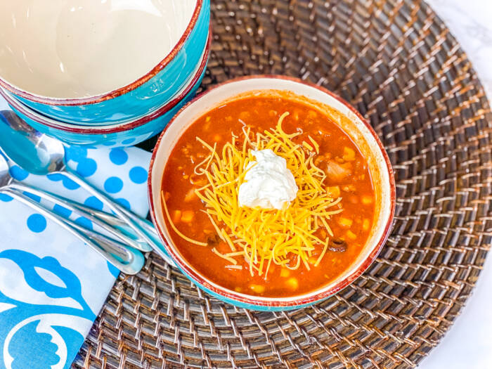 Taco Soup in blue bowls on brown mat