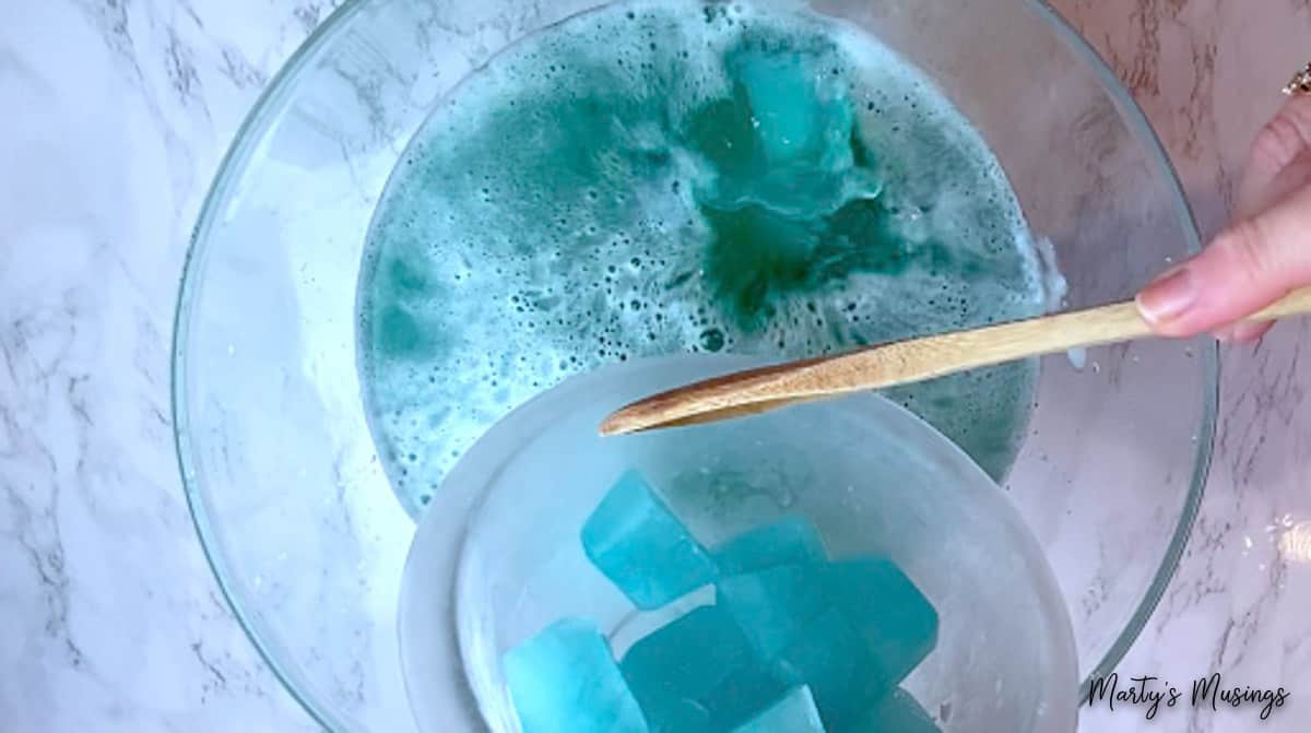 Blue ice cubes added to blue frozen punch