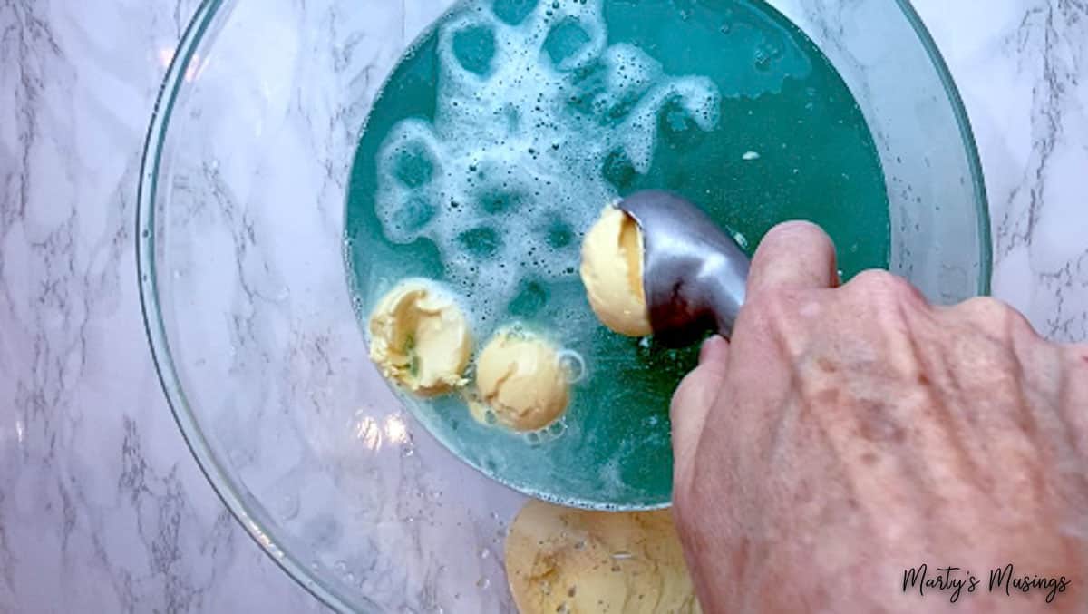 Vanilla ice cream scoops in blue frozen punch